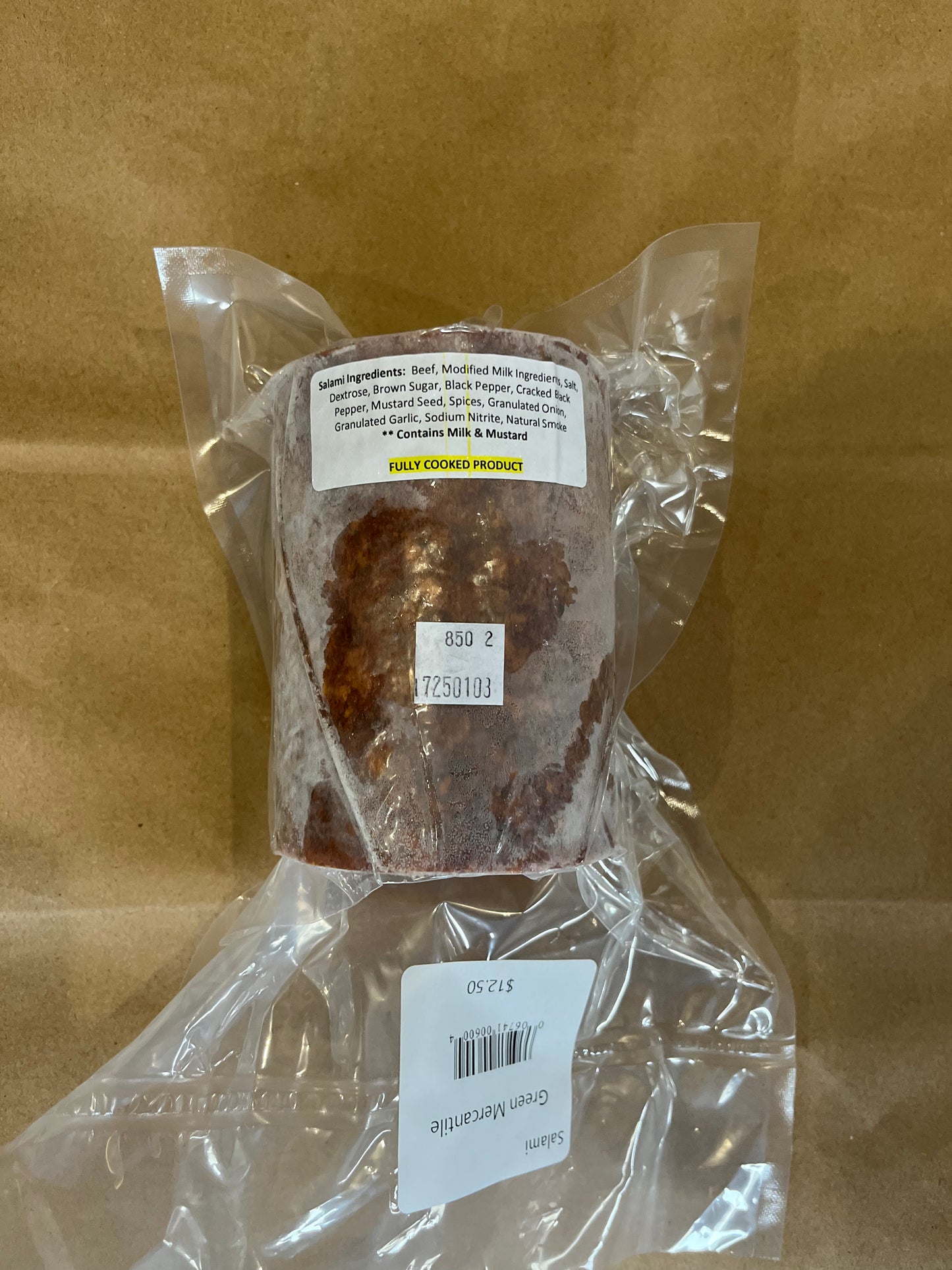 Packaged salami meat in a plastic bag with a label showing the product name and weight.